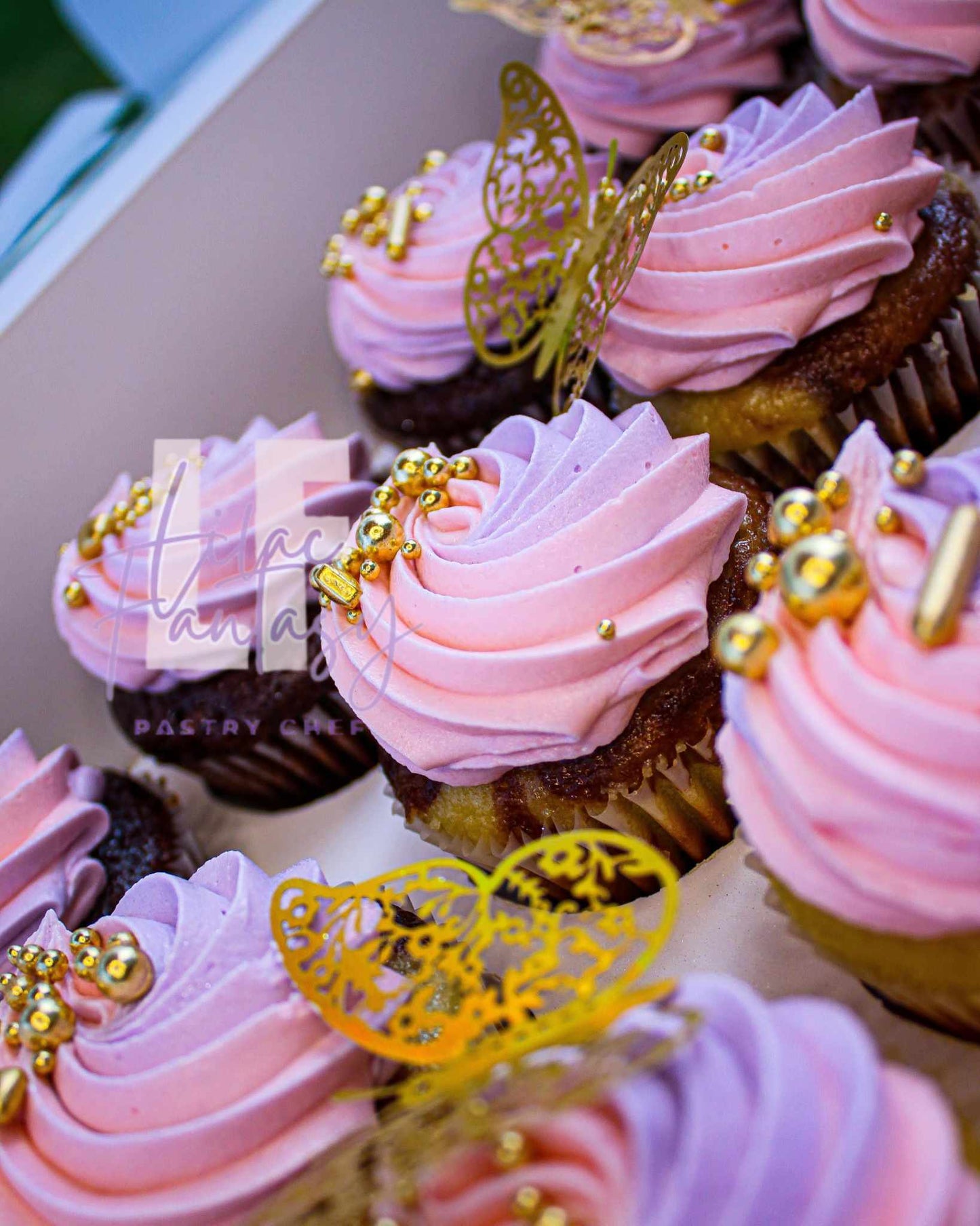 Multiple custom pink colored cupcakes by pastry chef Lilac