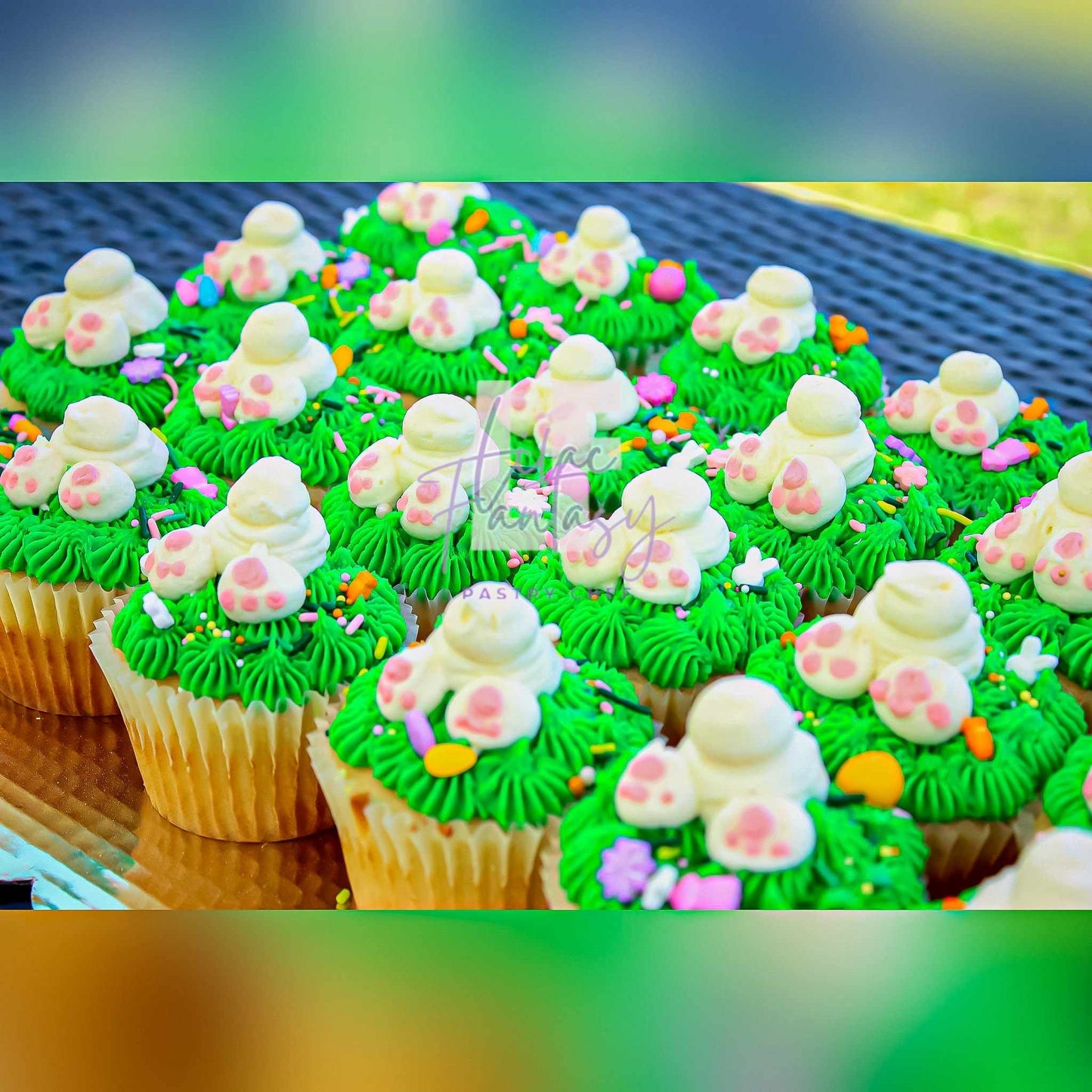 Multiple green colored custom cupcakes with the same design. Baked by chef Lilac