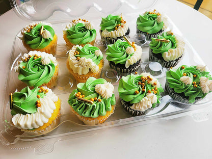 A dozen white and green cupcakes baked by pastry chef Lilac