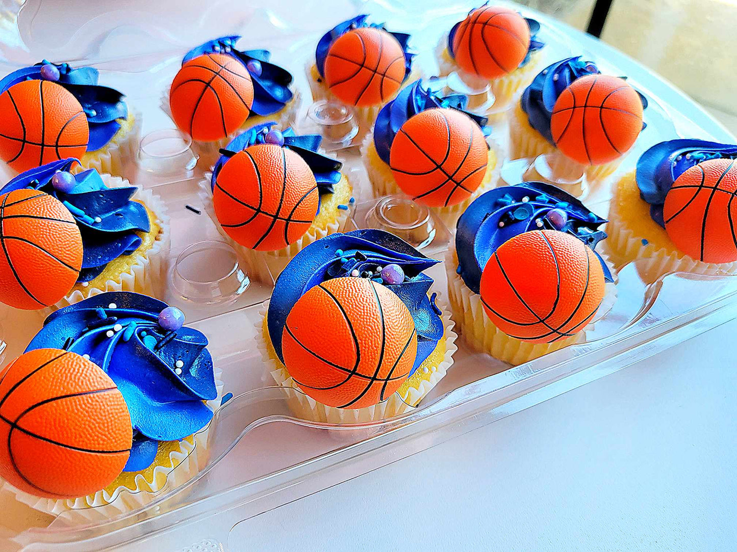 Custom dozen cupcakes with a basketball design by pastry chef Lilac